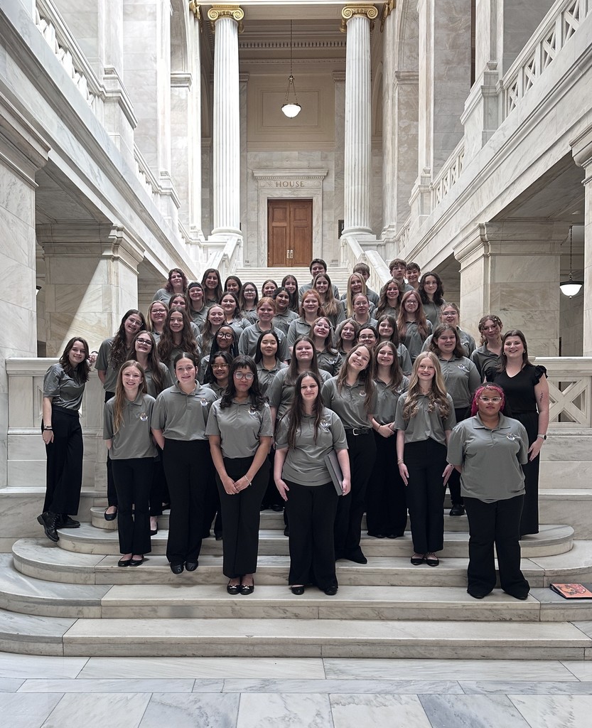group standing on steps inside Capitol building