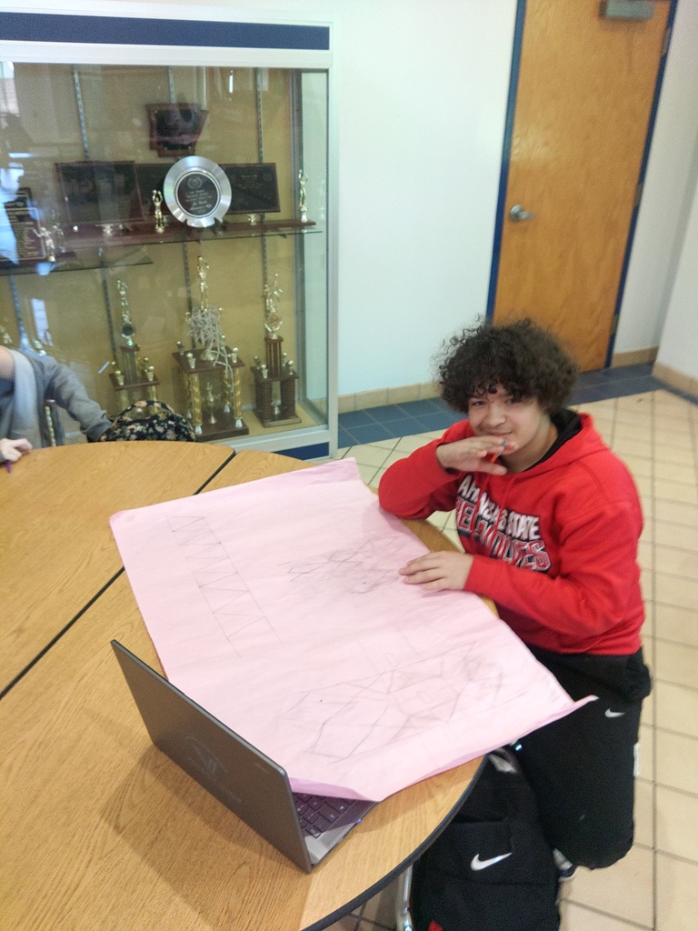 student lookin over his design