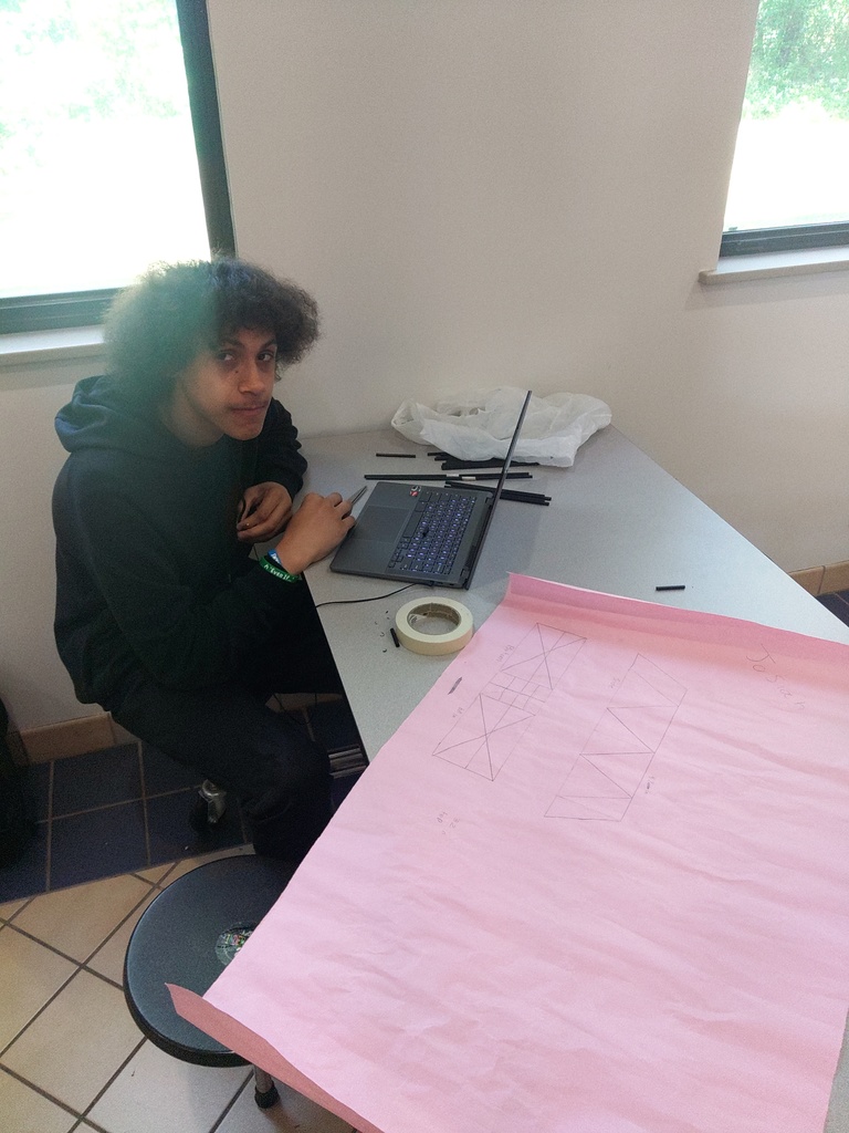 student with laptop working on project