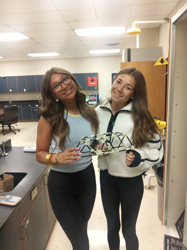 two girls holding bridge they created
