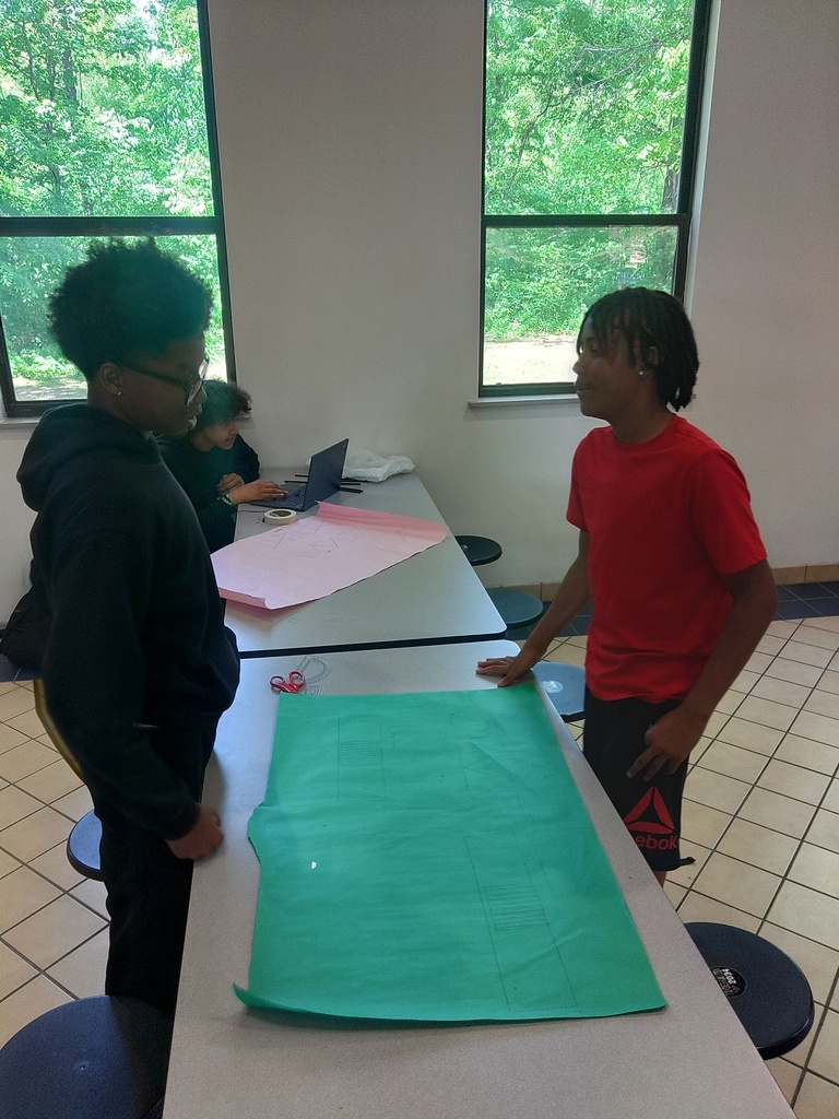 two students lookin at bridge design