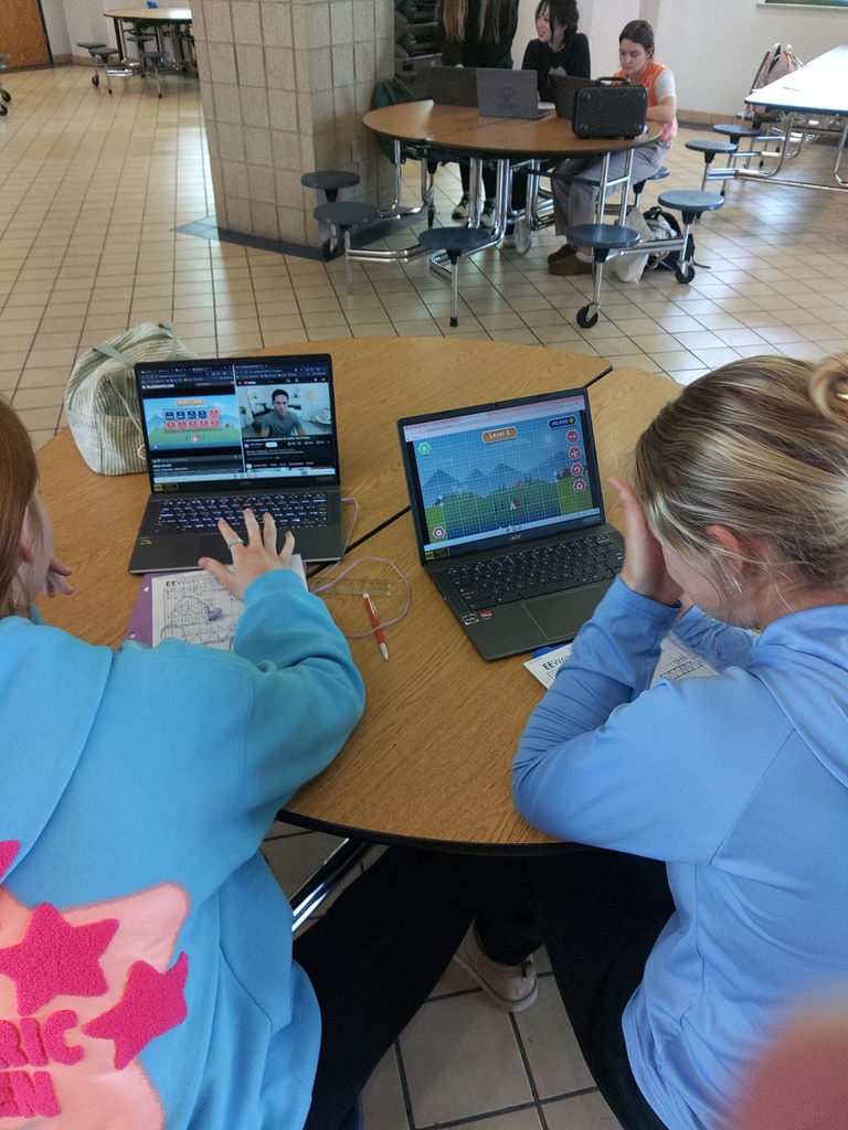 two girls working on bridge design