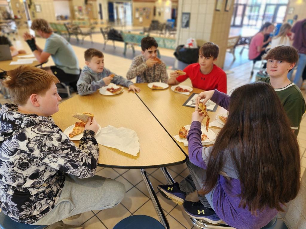 round table with several students seated and eating