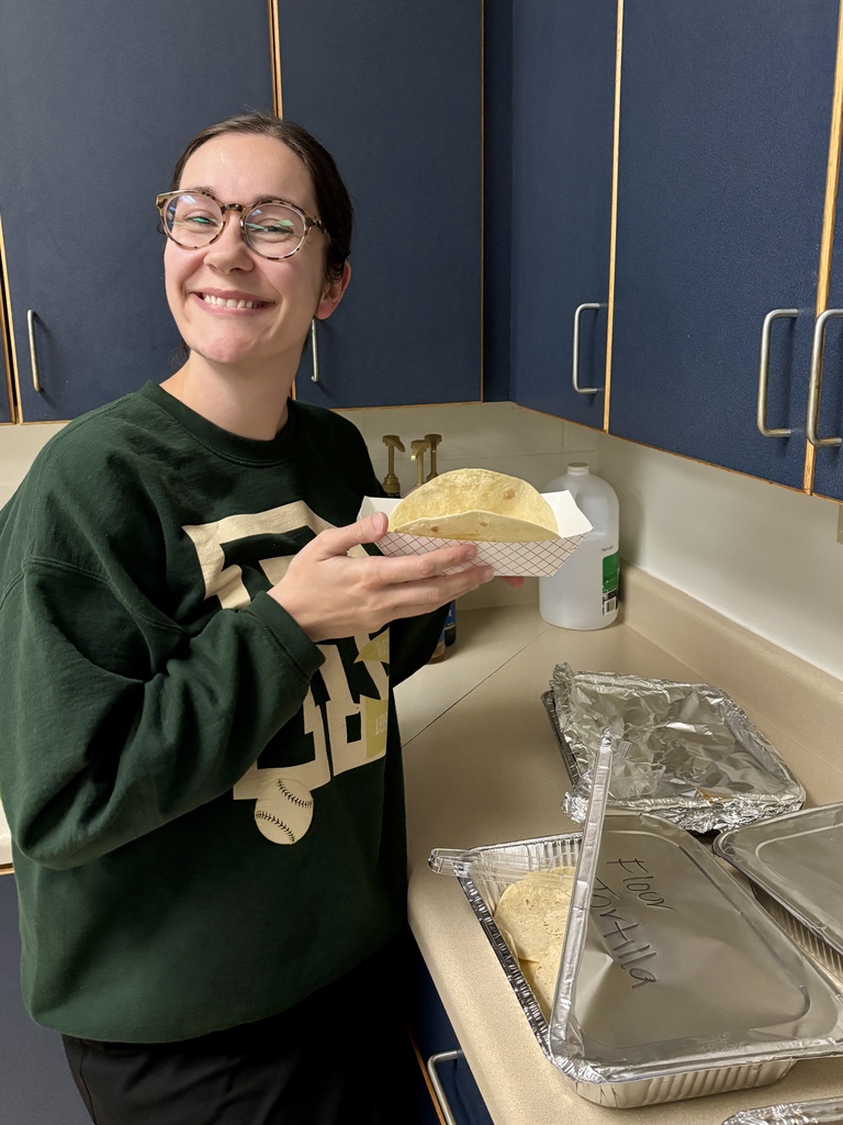 smiling teacher holding fajita