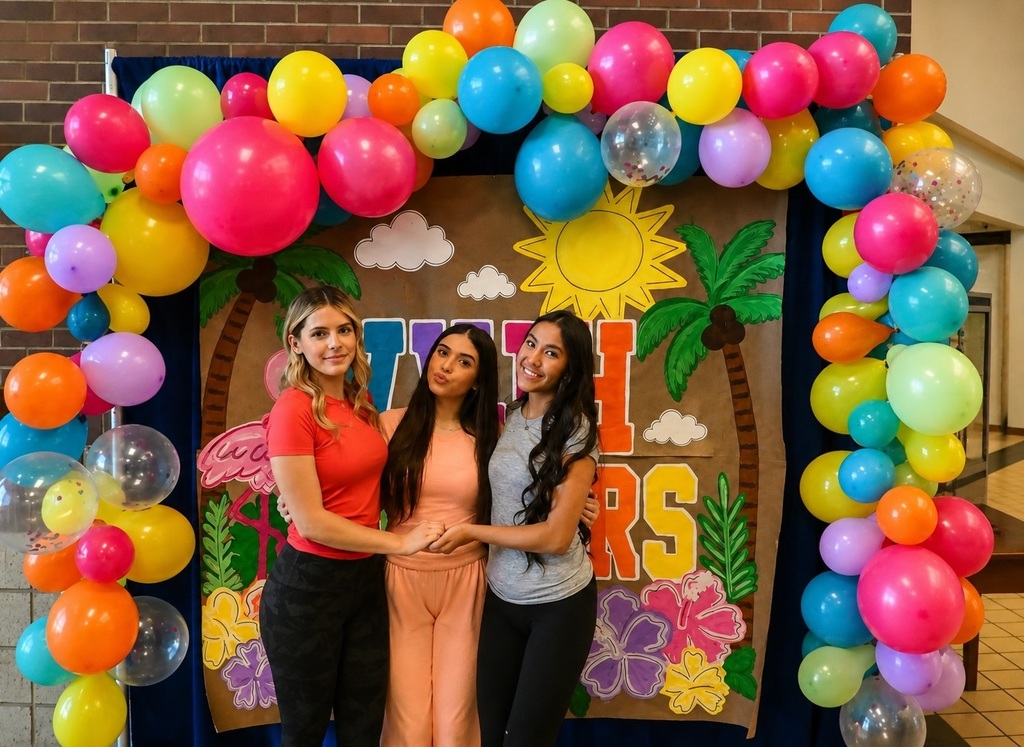 three girls under baloon arch 
