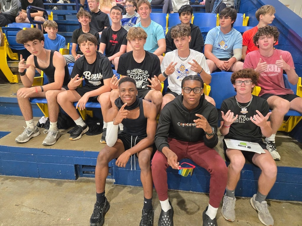 several boys seated in the gym before dodgeball started
