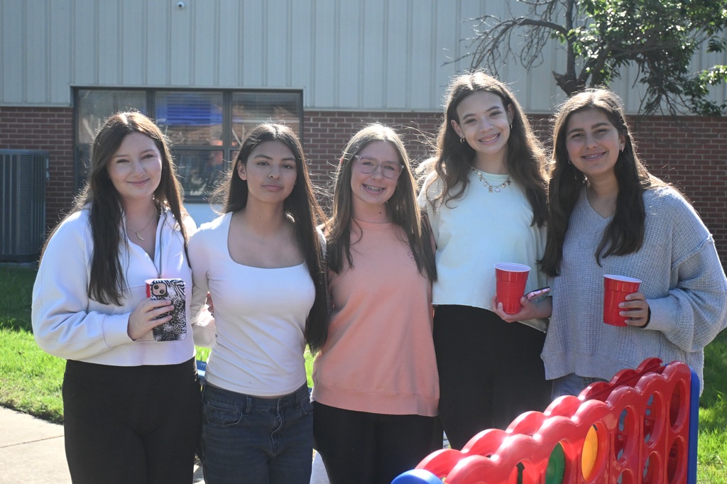 five girls posing together