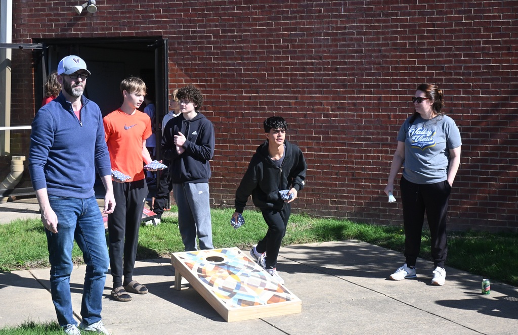 students playing cornhole bag toss