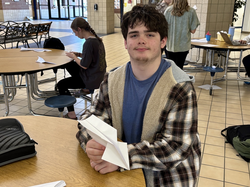 boy with his plane design in his hands