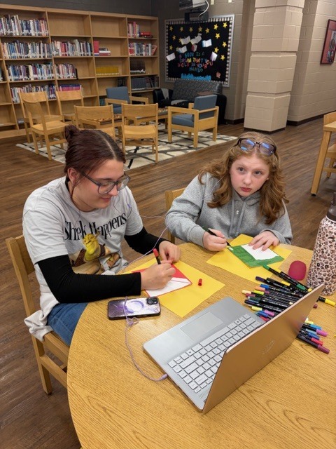 students in the library during afterschool working on project