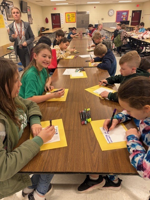 students in the cafeteria during afterschool working on project