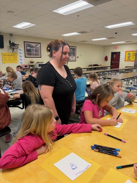 students in the cafeteria during afterschool working on project