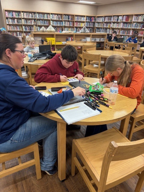 students in the library during afterschool working on project