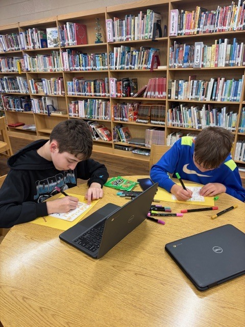 students in the library during afterschool working on project
