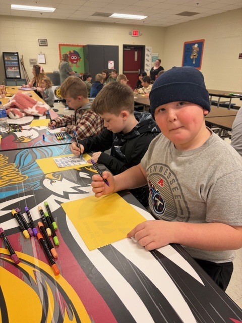 students in the cafeteria during afterschool working on project