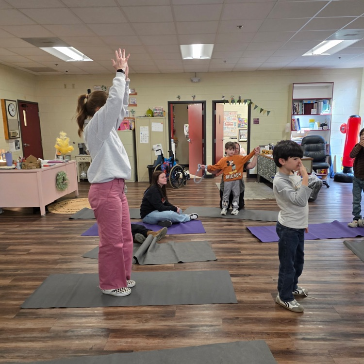 adult and students doing yoga