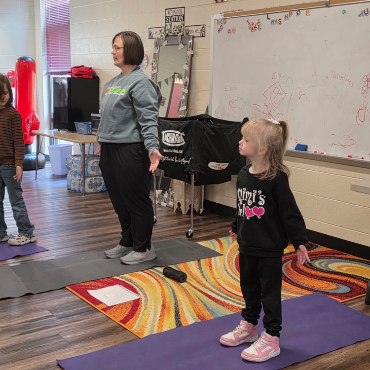 adult and students doing yoga