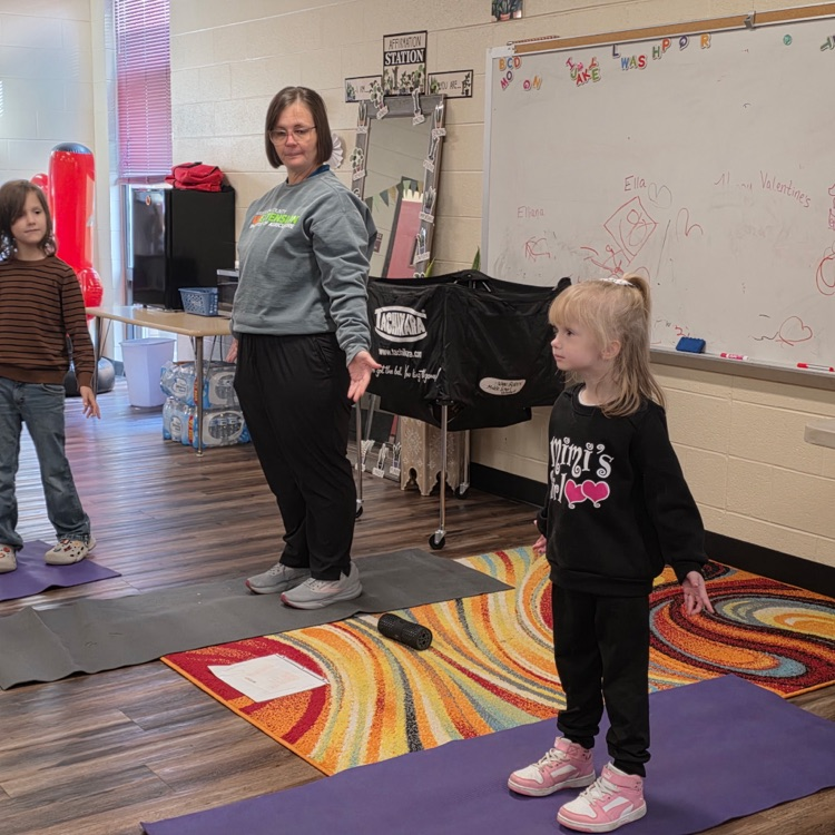 adult and students doing yoga