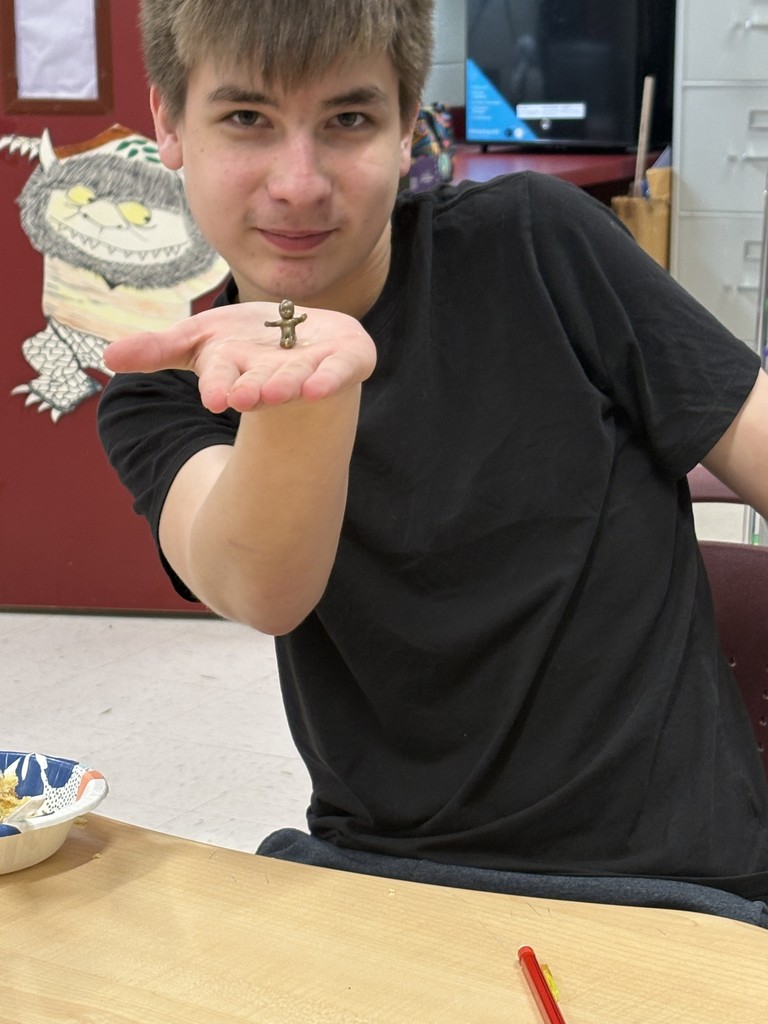 student holding baby Jesus from King Cake