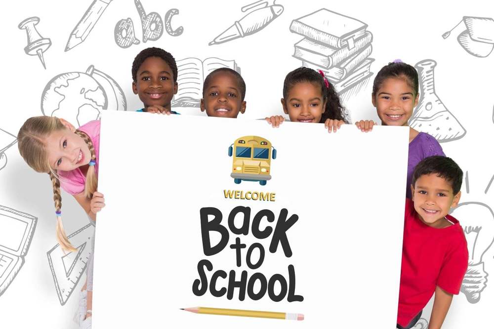 Kids holding back to school sign