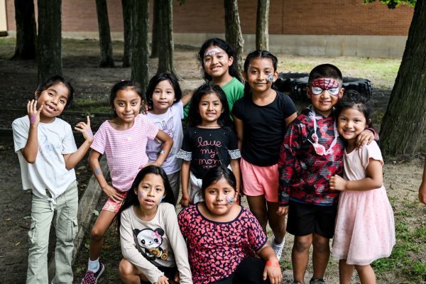 Migrant students smiling at the cameral