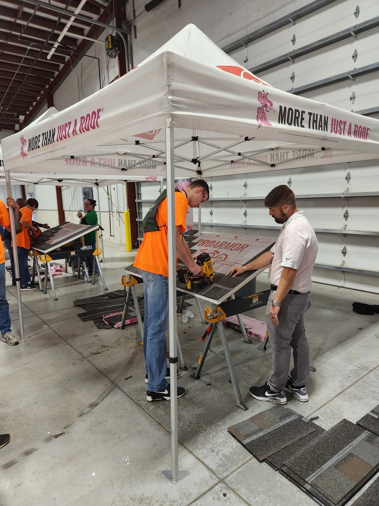 A student practices roofing.