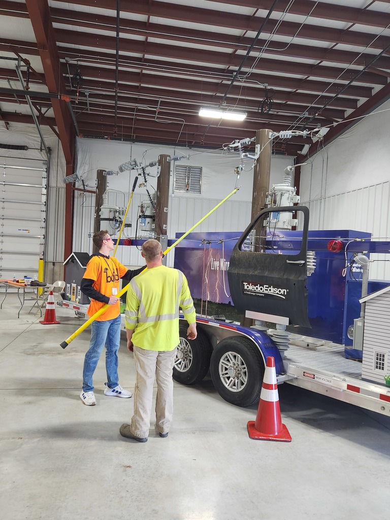 A student participates at the Toledo Edison booth.