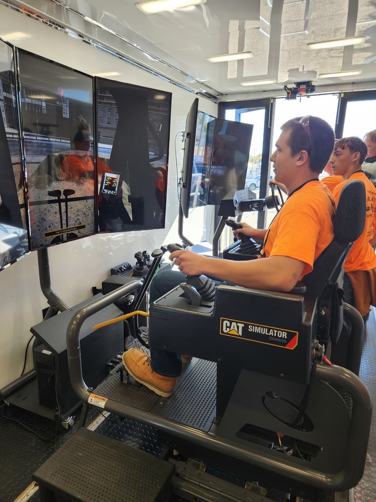 A student practices on a CAT simulator.