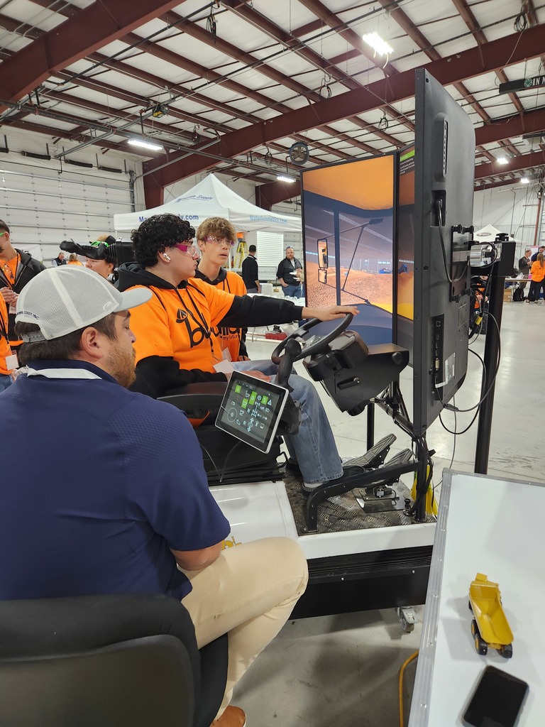 A student drives a truck simulator.
