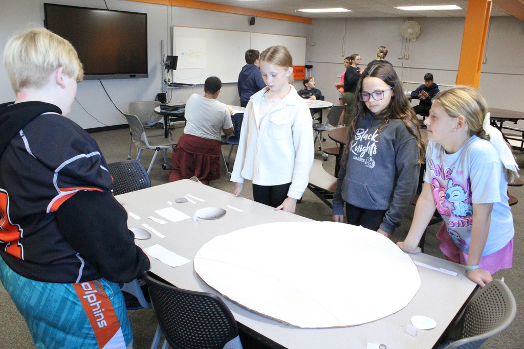 Students collaborate to learn about the solar system.