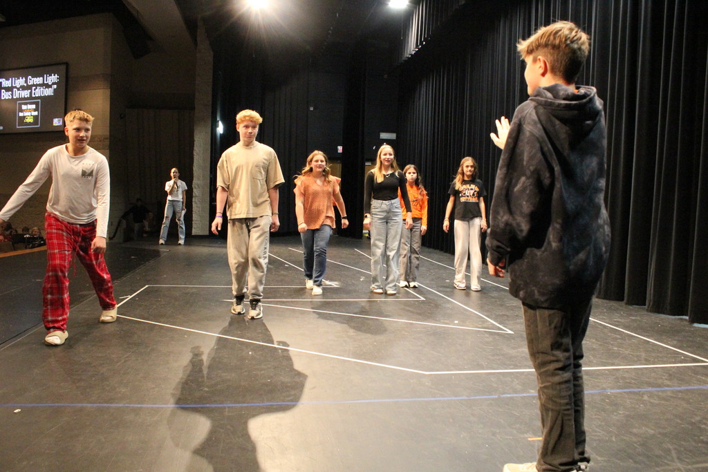 Students participate in a game of red light, green light.