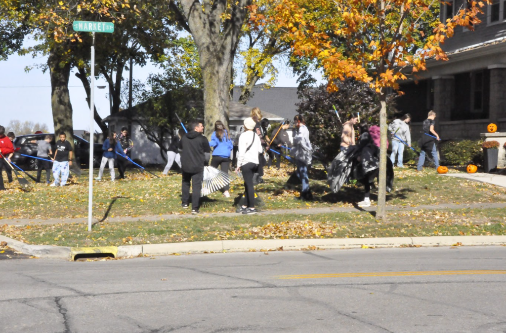 Students rake on Market Street.