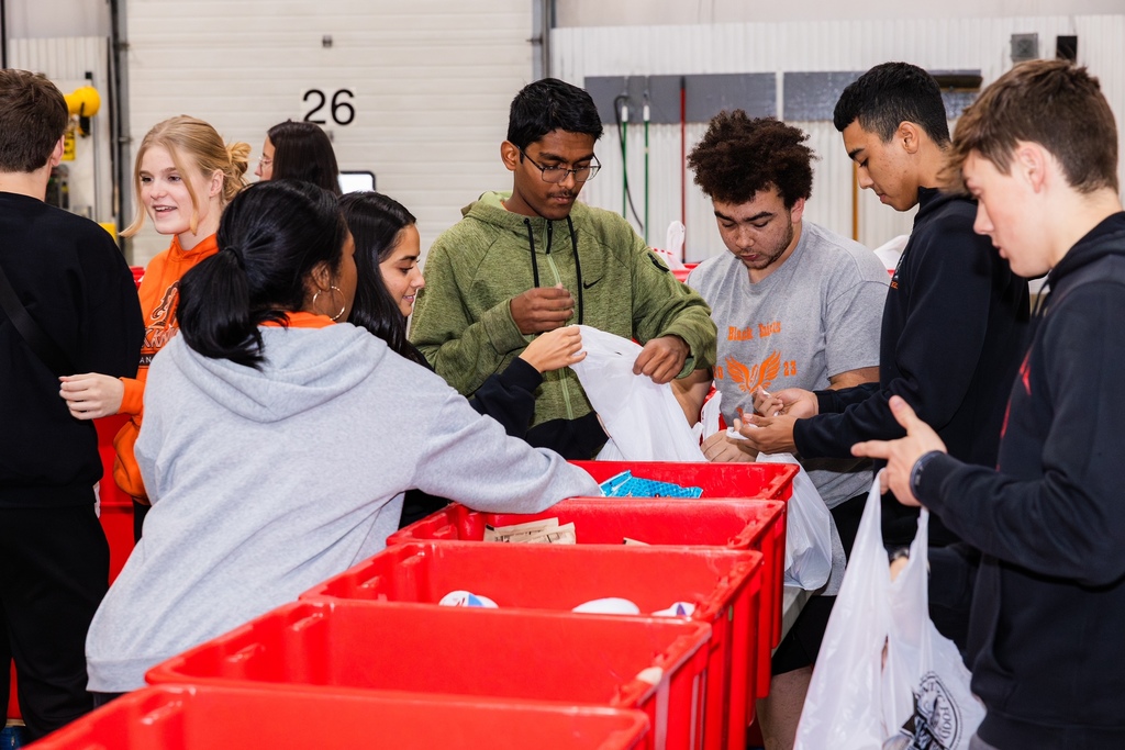Student Council members fill bags with food for Feed-A-Child.