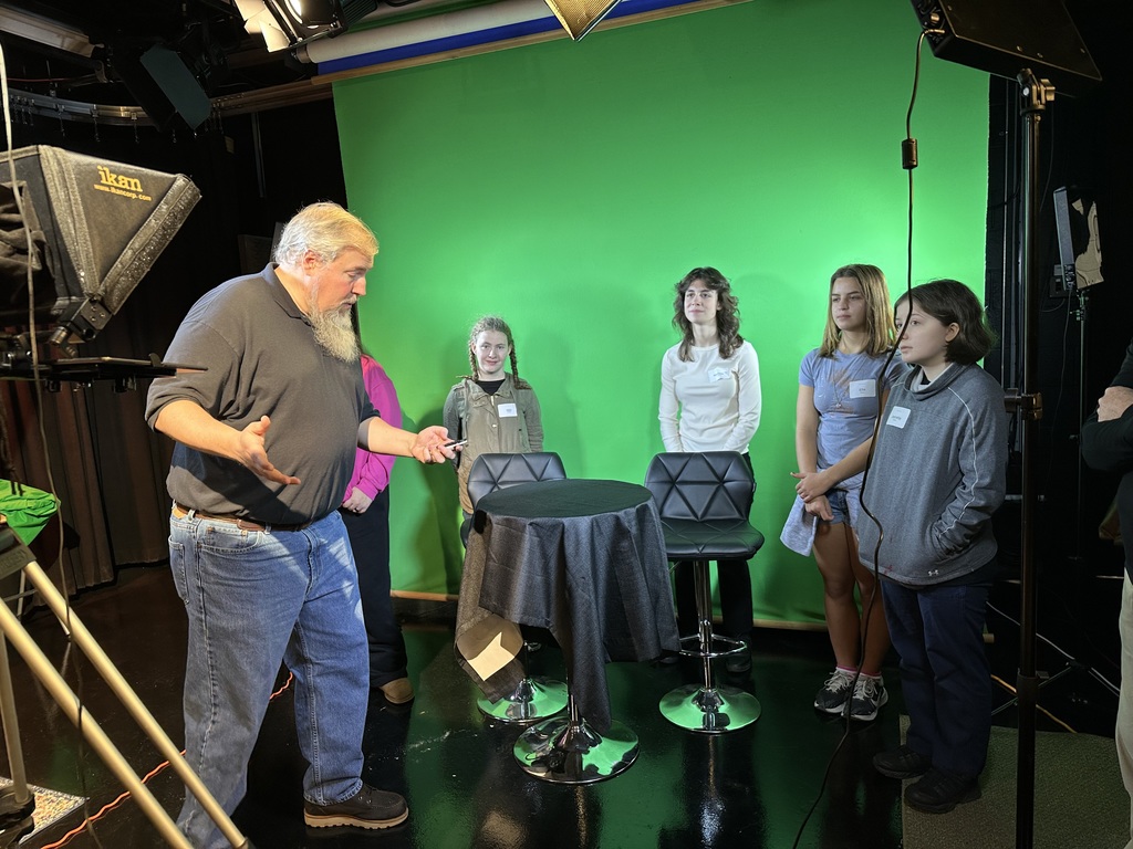 Students at the Arts, Entertainment, and Design Career Expo learn about using a green screen at the UF TV studio.