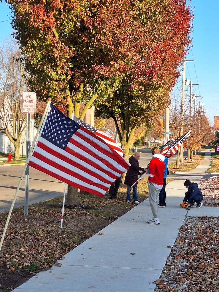 Students from Mrs. Obenour and Mr. Woodard's classes help remove the flags after Veteran's Day.
