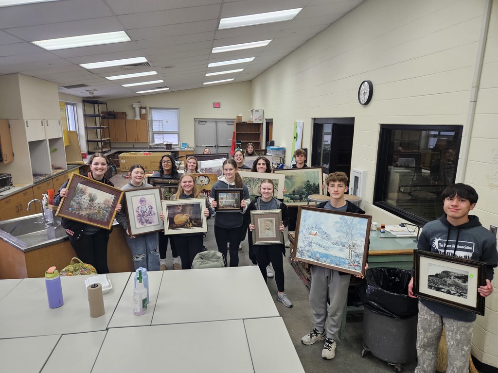Students pose with the pieces they will be transforming for the Habitat art auction.