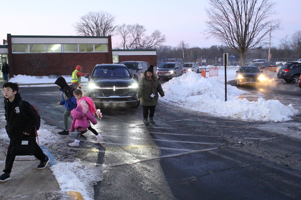 Mrs. Shanda Still ensures traffic stops for students as they use the crosswalk.