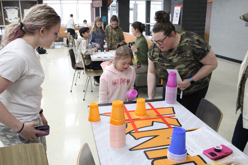 Two students play a unique take on the classic tic-tac-toe game.