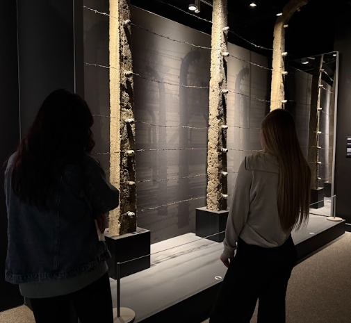 Students observe a portion of the barbed wire fence that once surrounded Auschwitz.