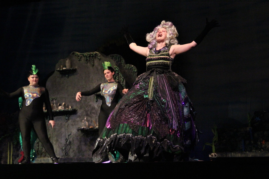 Ursula (Emily) lets out a roar as her minions (Kamille and Elyse) admire her power.