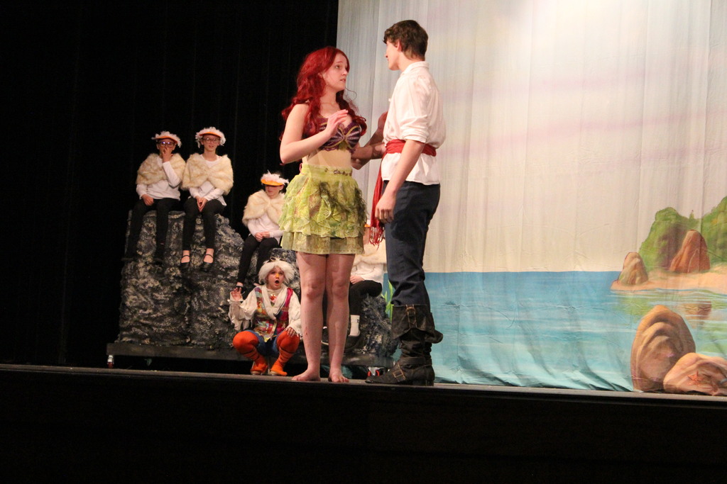 Ariel (Kate) and Prince Eric (Cullen) talk to the amazement of Scuttle (Hailey) and the other seagulls.