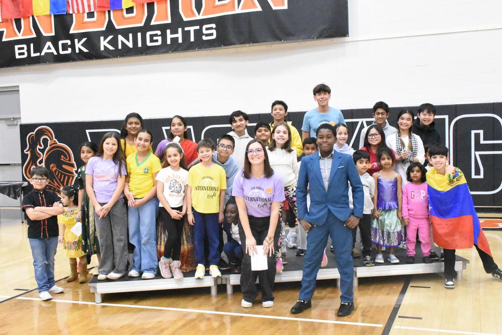 Mrs. Leonard's students pose with her at International Knight.