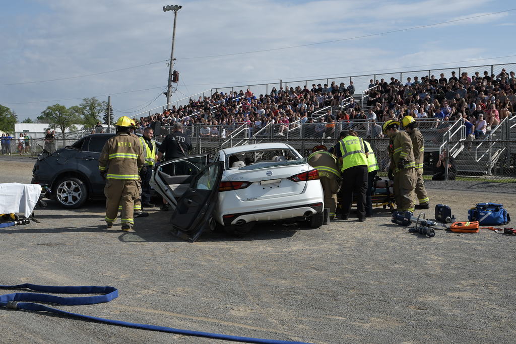 First responders manage the scene of the mock crash as students from across Hancock County observe.
