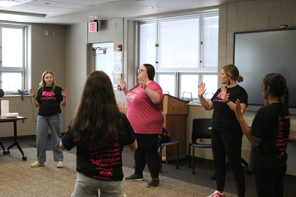 Mrs. Limes and Mrs. Barrett lead the girls through an activity.