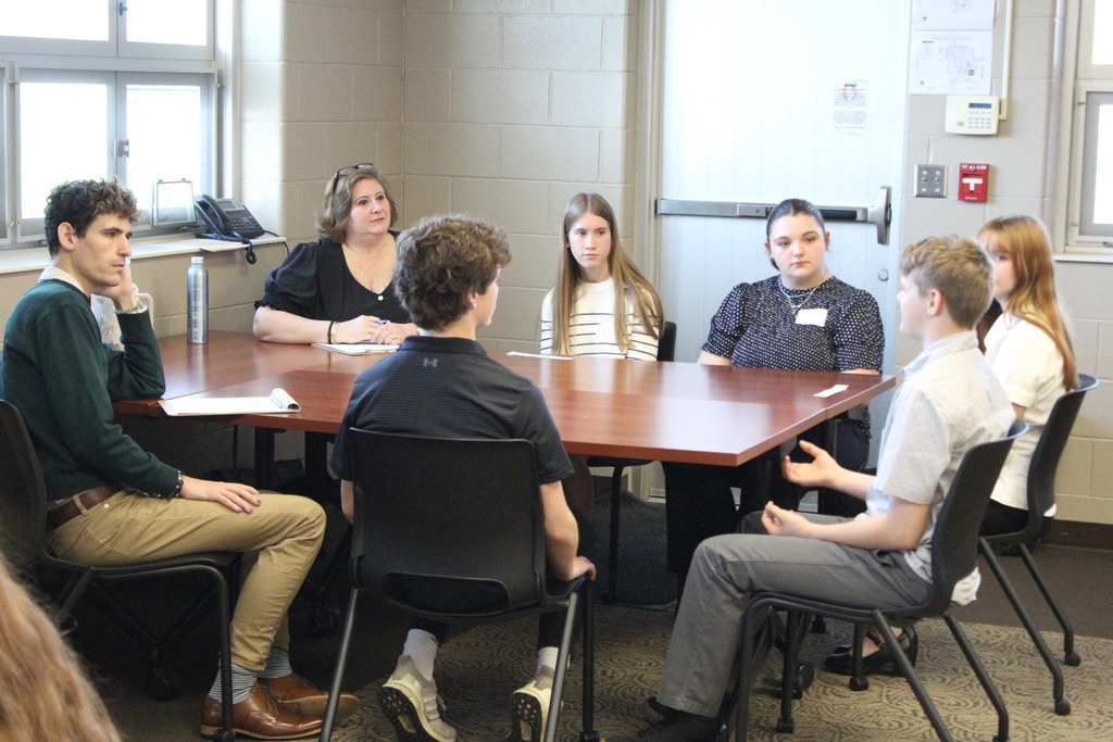 Students listen to a comment during the Circle of Doom Challenge.