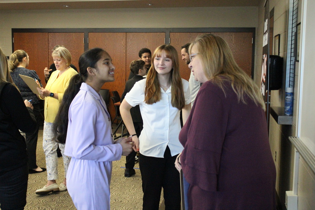 Students chat with a judge during the Work the Room Challenge.