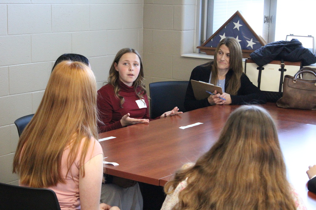 Students carry on a conversation during the Circle of Doom Challenge.