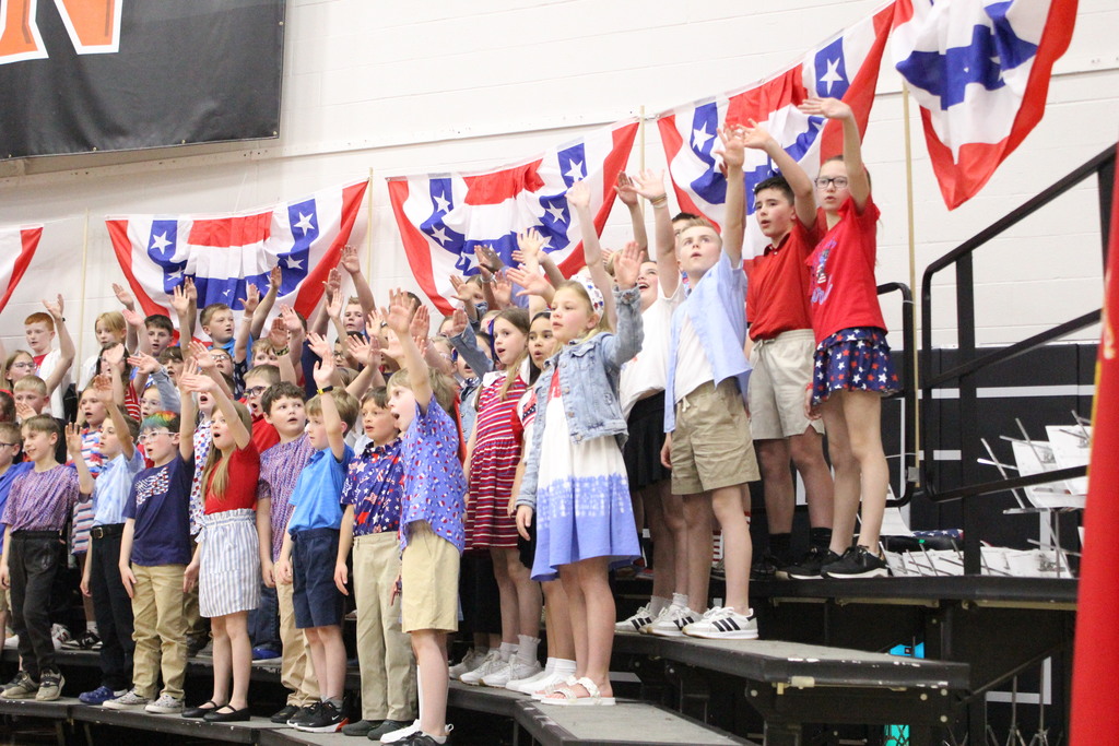 Students sing "Because of You" for the veterans and troops in the audience.