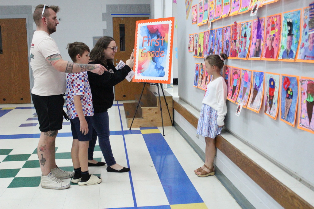 A student poses in front of her artwork.