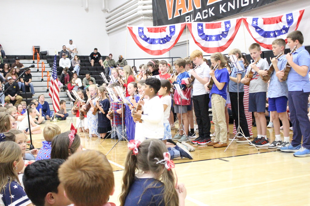 Students play "Yankee Doodle" on ukuleles.